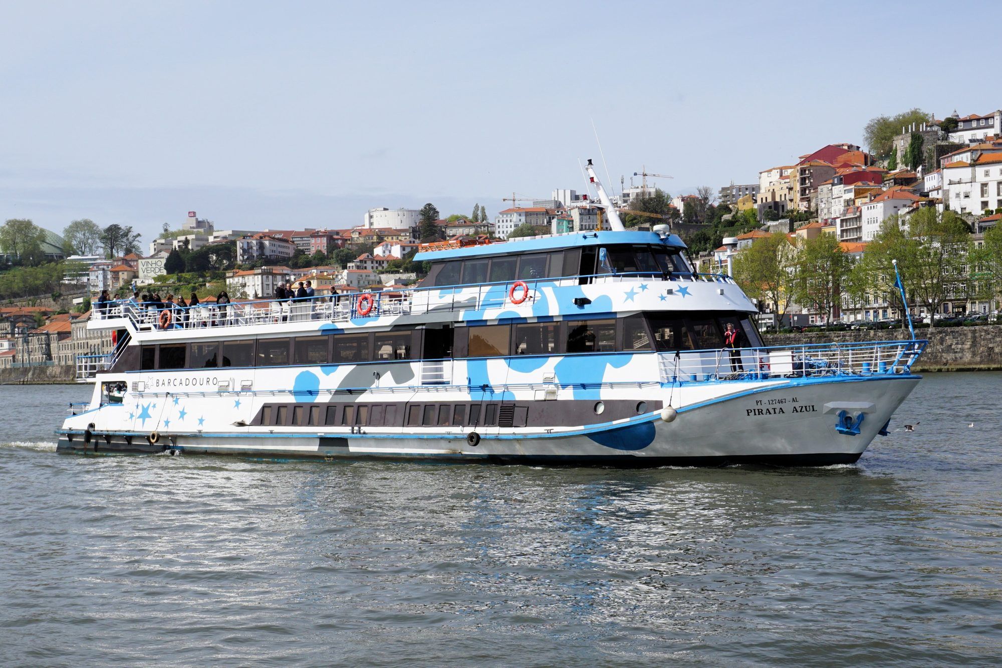Rabelo-style tourist boat passing under the Ponte Luís I on the Douro at Vila Nova de Gaia